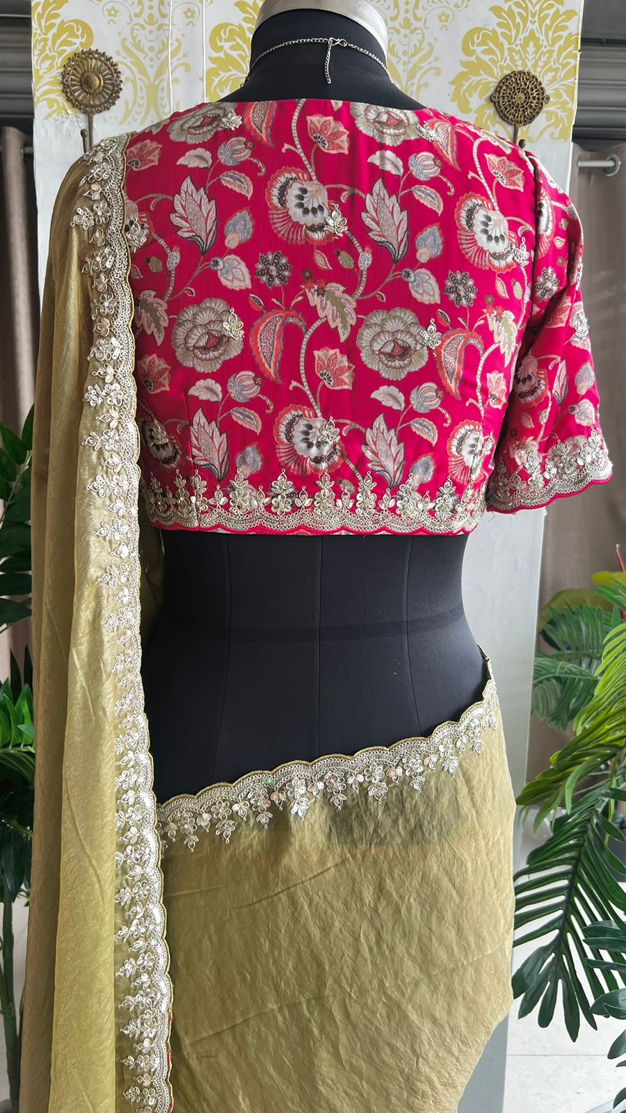 Green soft tissue saree with pink floral embroidered blouse