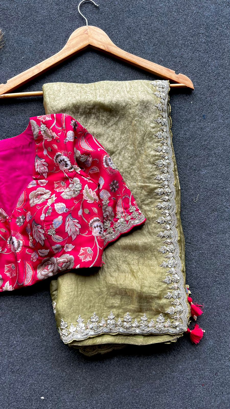 Green soft tissue saree with pink floral embroidered blouse