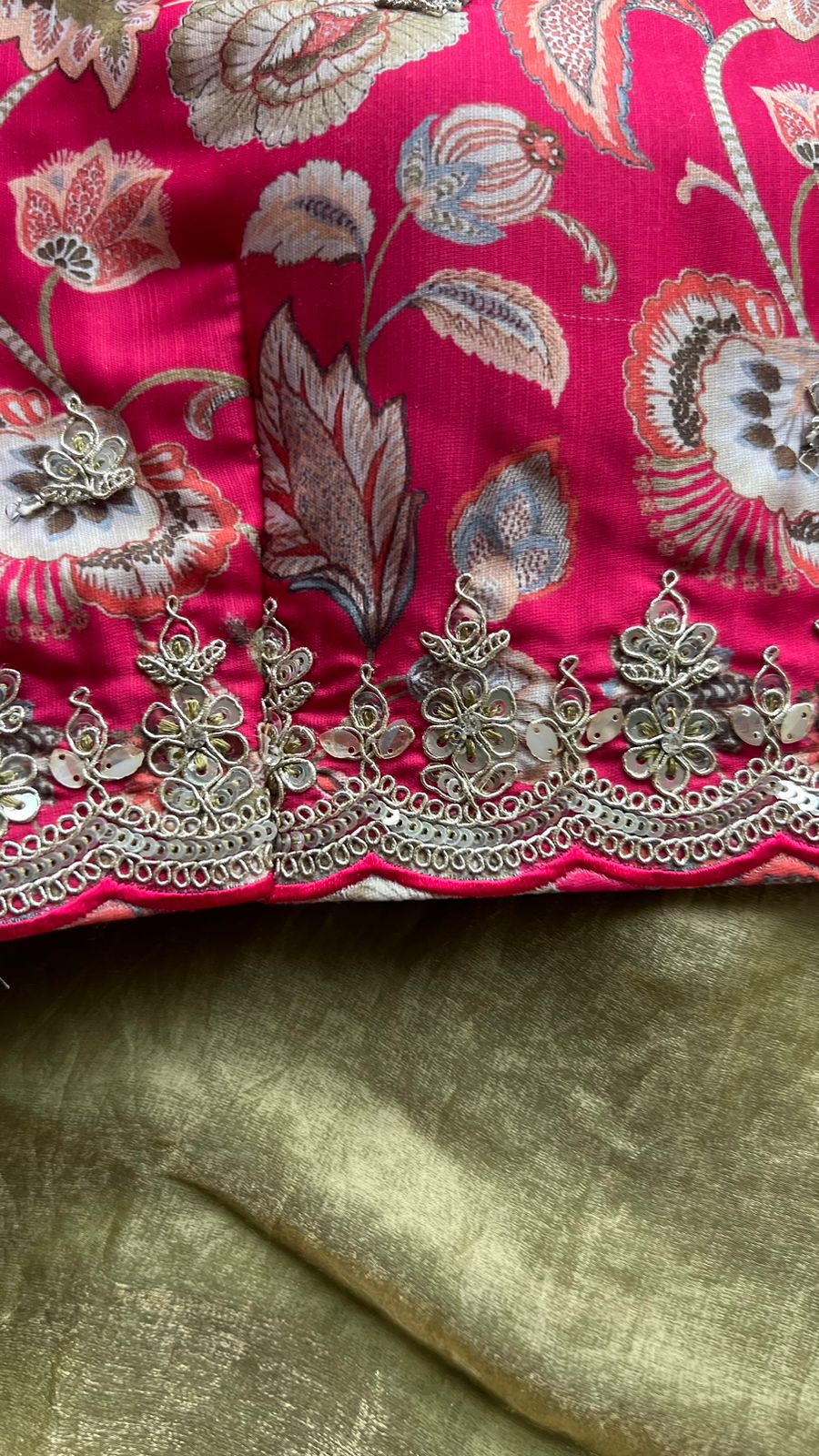 Green soft tissue saree with pink floral embroidered blouse