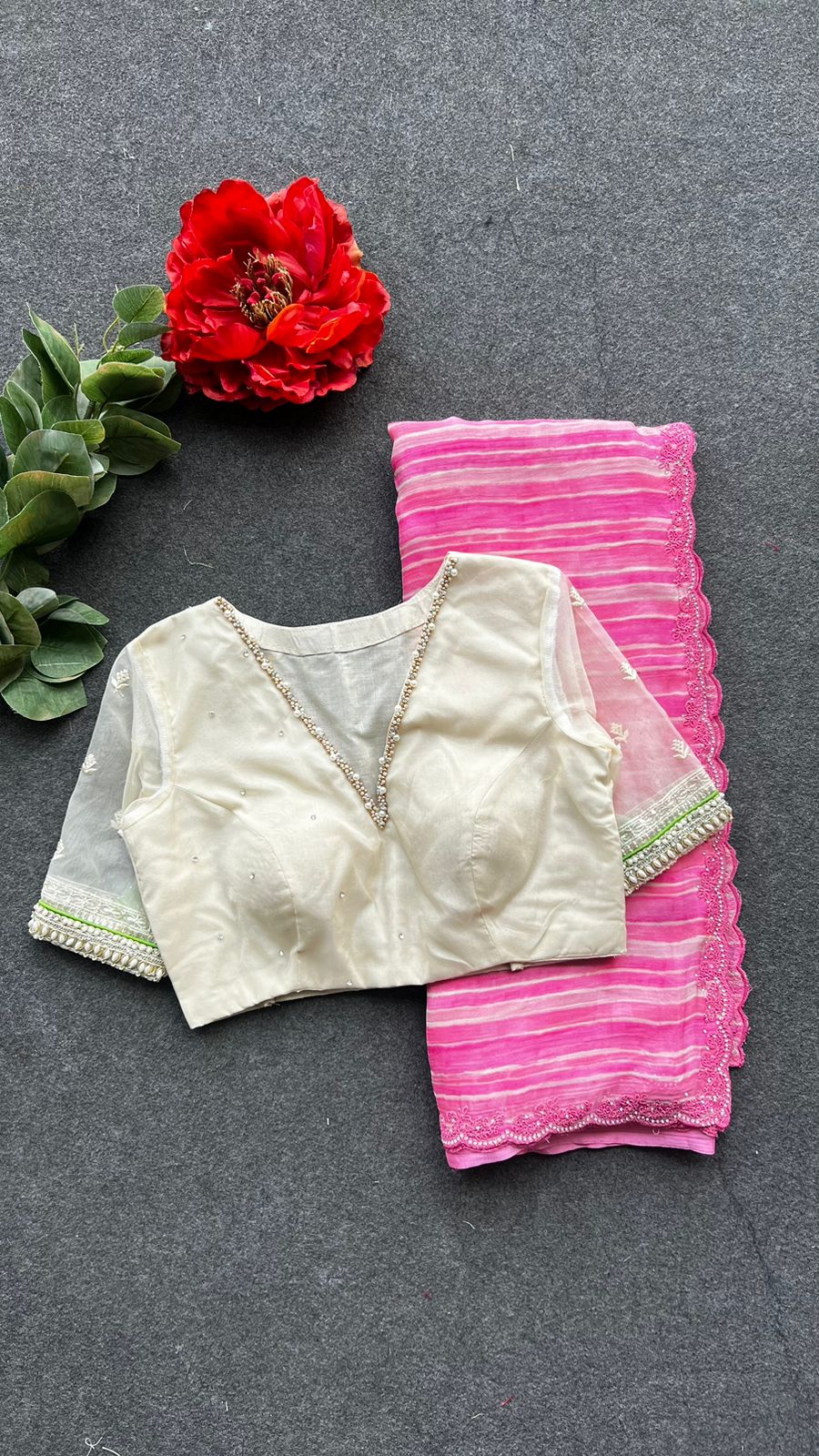 Pink chiffon stripped saree with cream hand work blouse