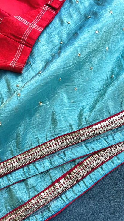 Blue glass tissue saree with red tussar silk hand work blouse