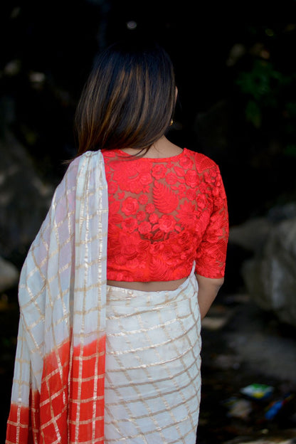 Cream chiffon saree with red thread embroidery blouse