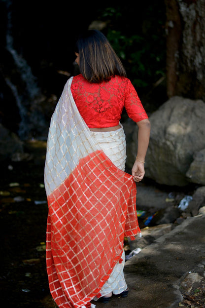 Cream chiffon saree with red thread embroidery blouse