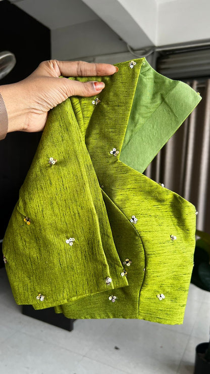 Blue stripped tissue saree with green hand worked blouse