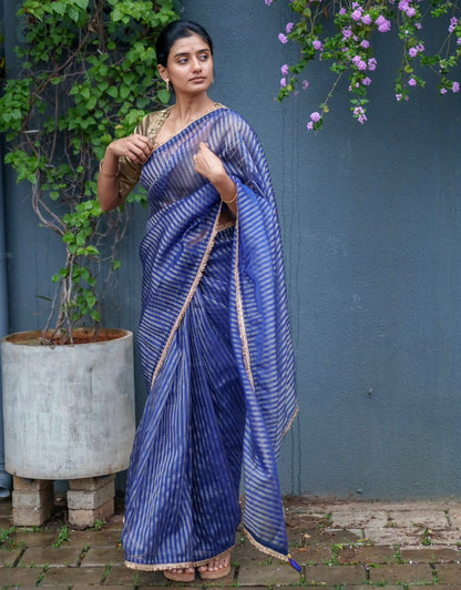 Blue stripped tissue saree with golden hand worked blouse