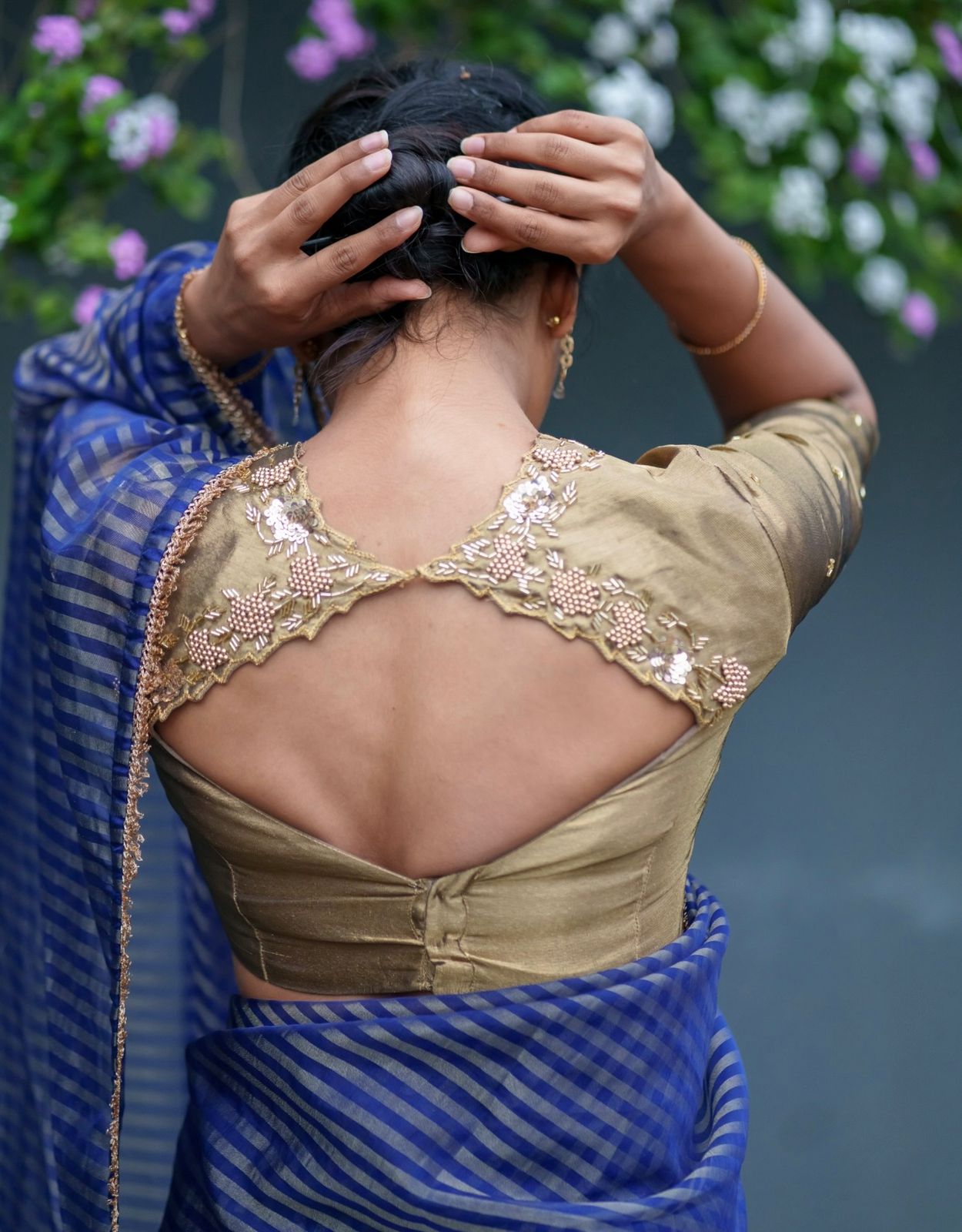 Blue stripped tissue saree with golden hand worked blouse