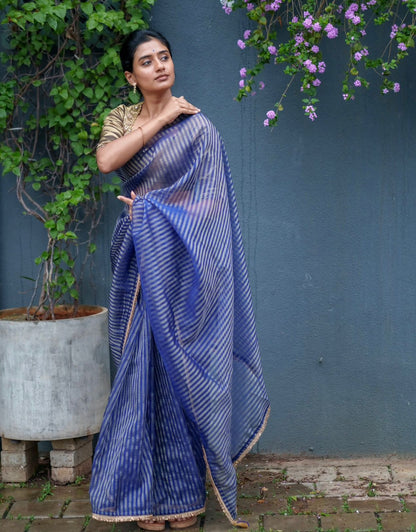 Blue stripped tissue saree with golden hand worked blouse