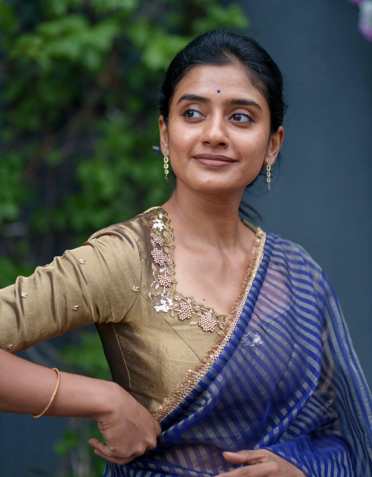 Blue stripped tissue saree with golden hand worked blouse