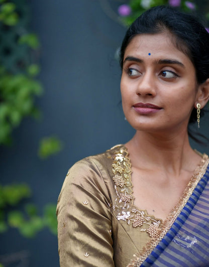 Blue stripped tissue saree with golden hand worked blouse