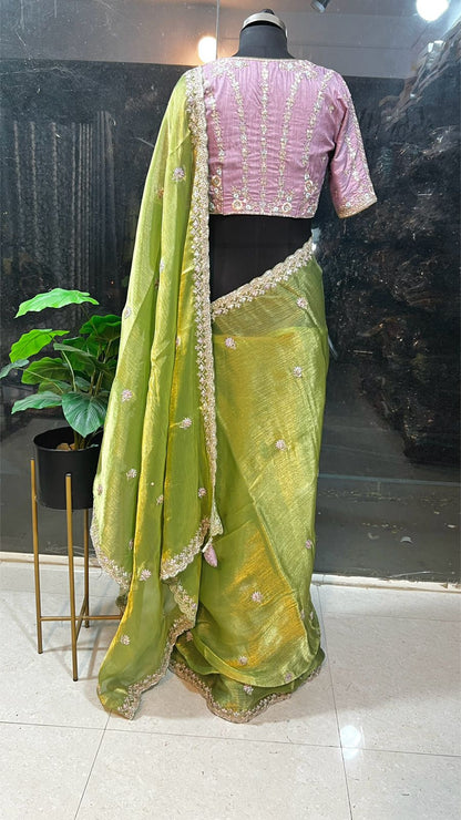 Green tissue saree with lavender embroidered blouse