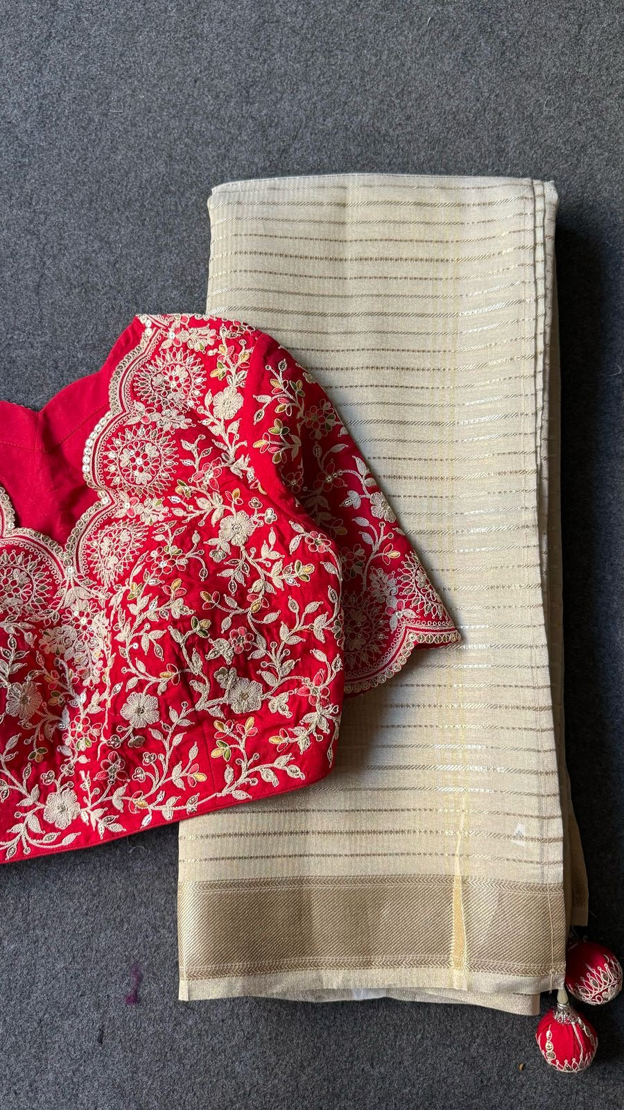 Cream tissue stripped saree with red silk hand work blouse