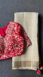 Cream tissue stripped saree with red silk hand work blouse