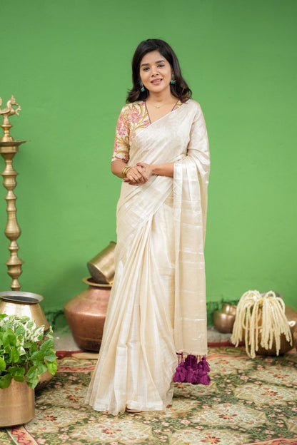Cream soft tissue saree with embroidered blouse