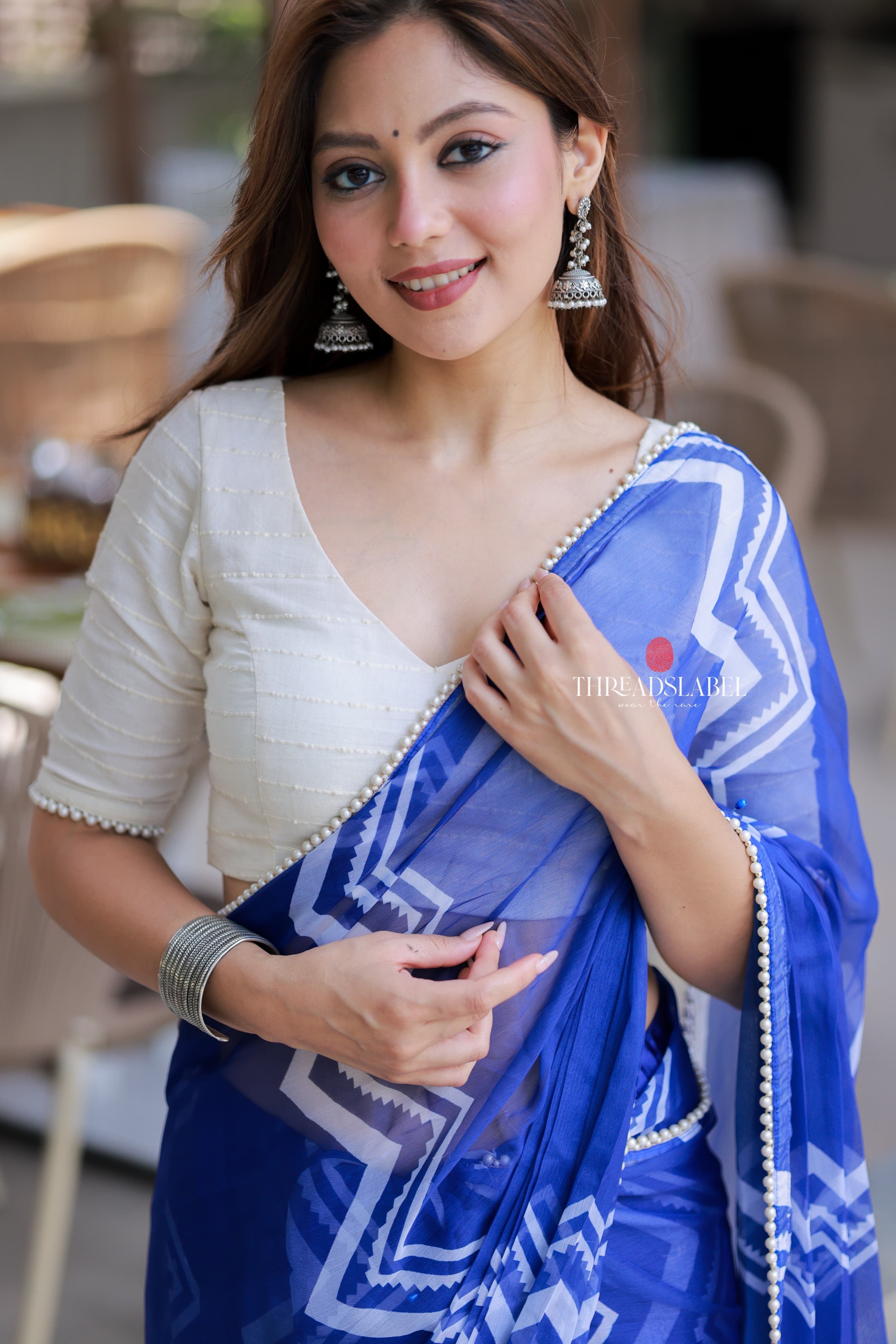 Blue chiffon saree with white embroidery blouse