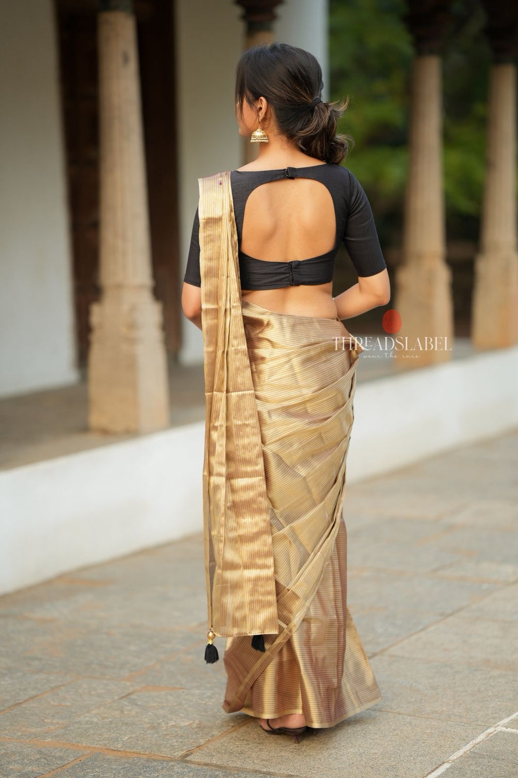 Golden tissue saree with black hand work blouse