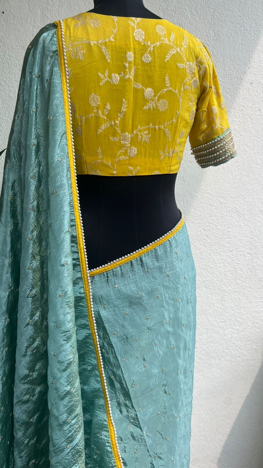 Blue glass tissue saree with yellow banarasi blouse