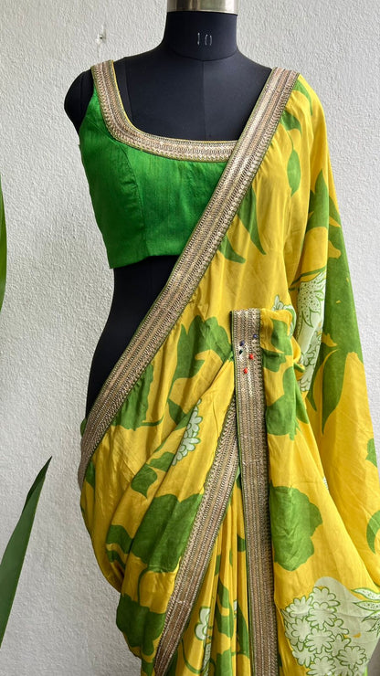 Yellow viscose saree with green silk embroidered blouse