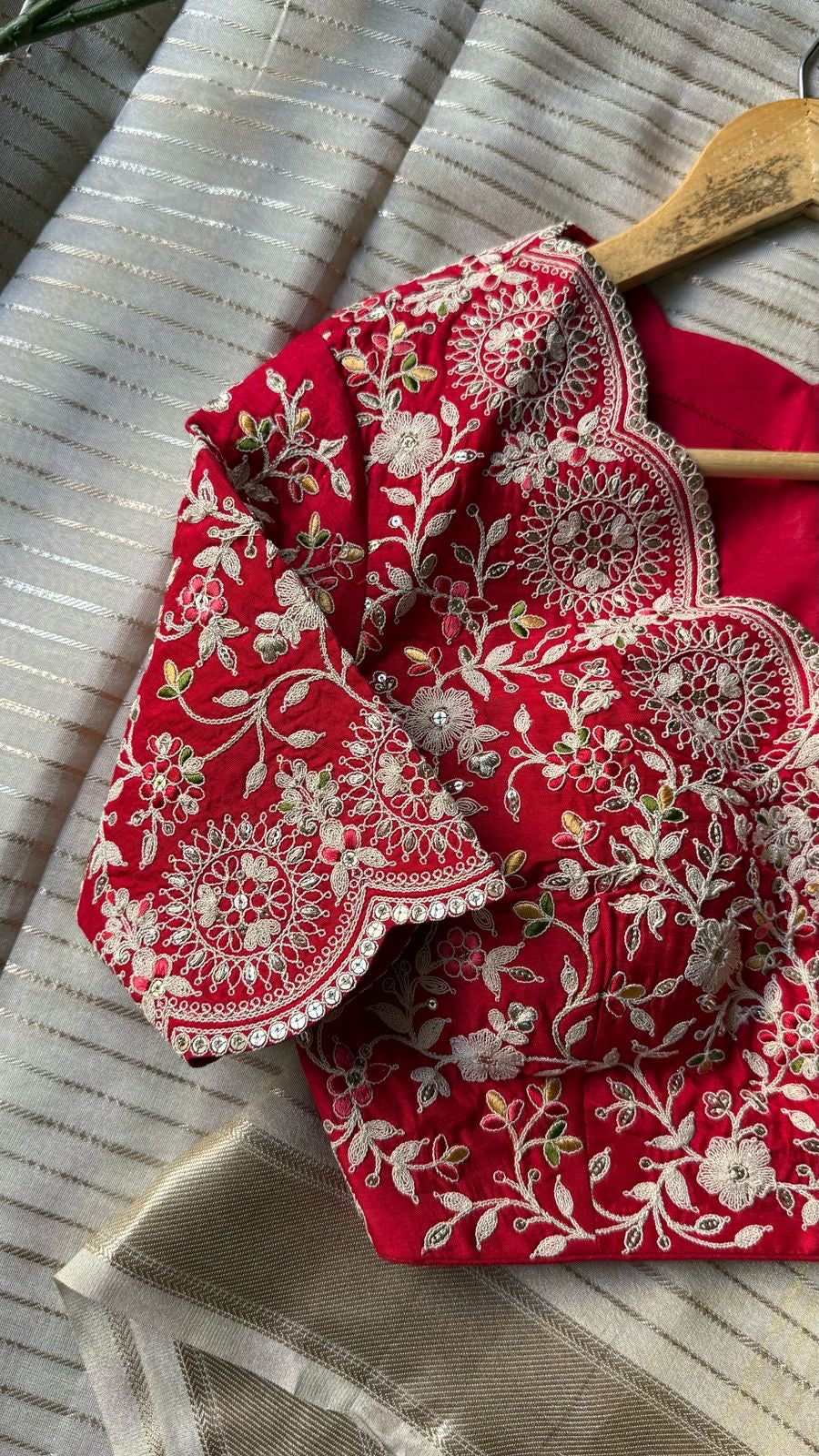 Cream tissue stripped saree with red silk hand work blouse