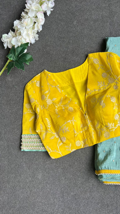 Blue glass tissue saree with yellow banarasi blouse