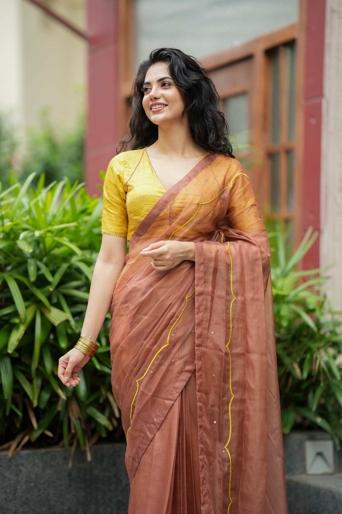 Brown soft organza saree with lime green ikkat blouse