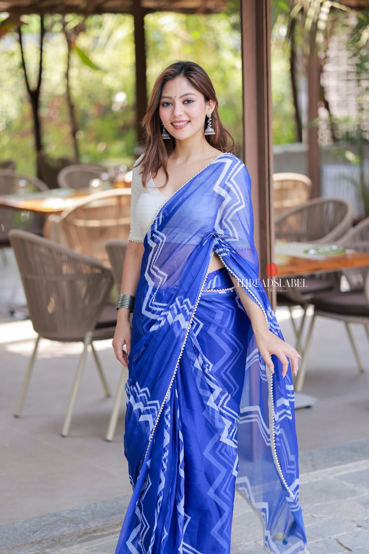 Blue chiffon saree with white embroidery blouse