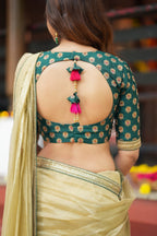 Gold tissue saree with green hand work blouse