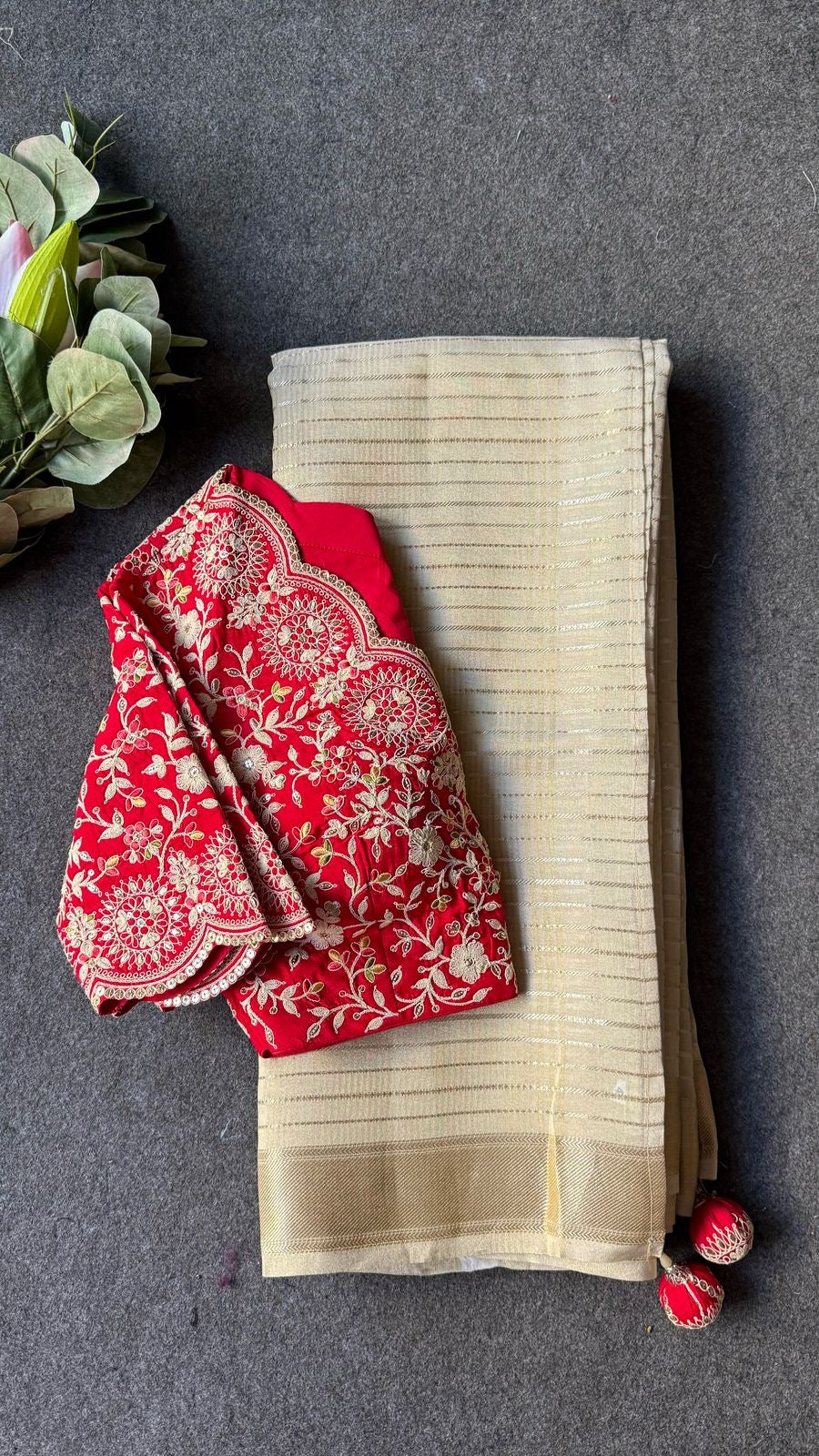 Cream tissue stripped saree with red silk hand work blouse
