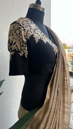 Golden cream tissue saree with black hand work blouse