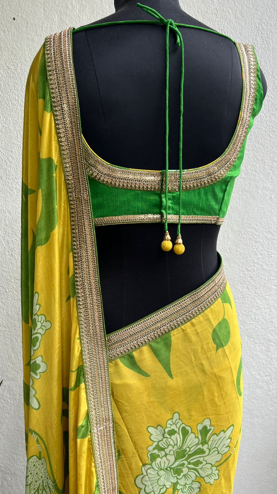 Yellow viscose saree with green silk embroidered blouse