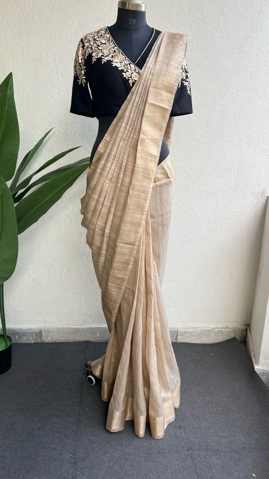 Golden cream tissue saree with black hand work blouse