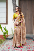 Antique gold tissue saree with parrot handwork blouse