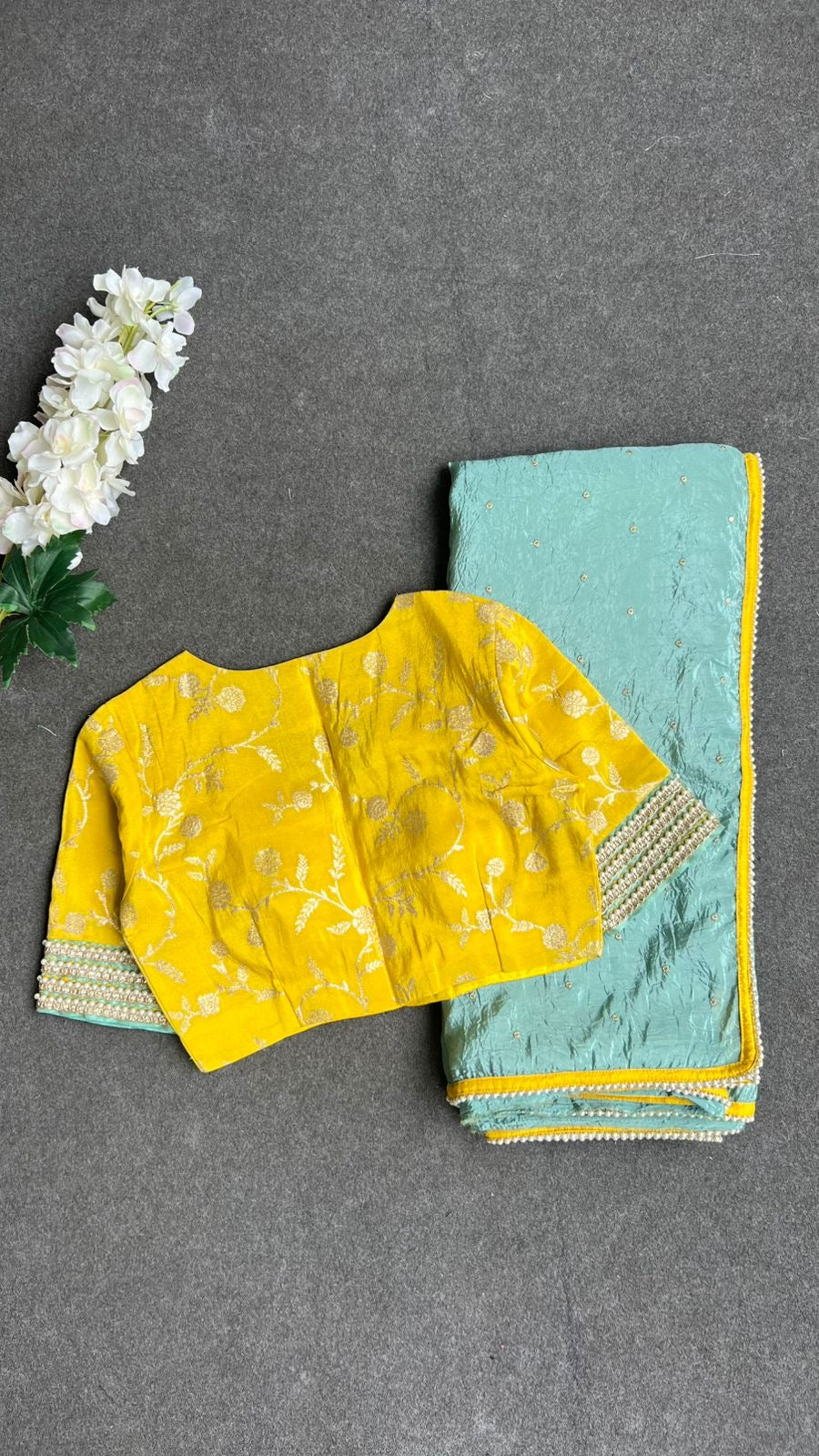 Blue glass tissue saree with yellow banarasi blouse