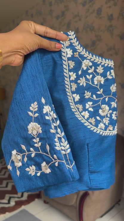 Half-white Blue floral organza saree with brown hand worked blouse