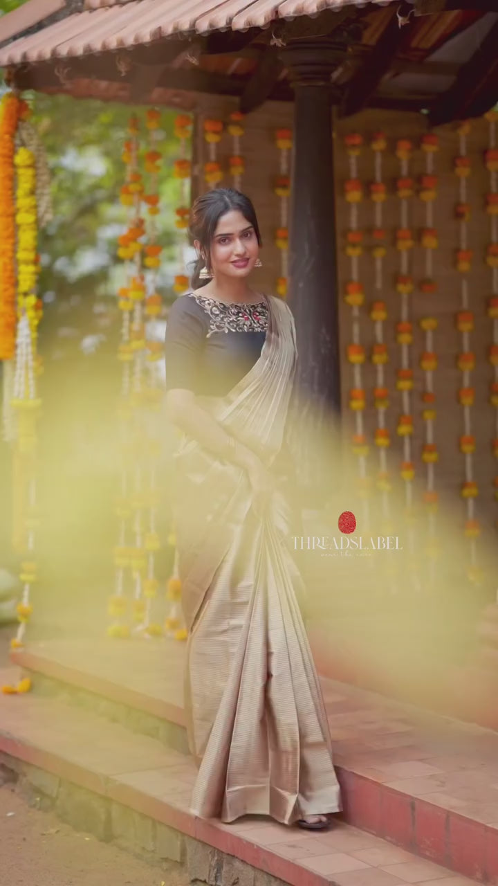 Golden tissue saree with black hand work blouse