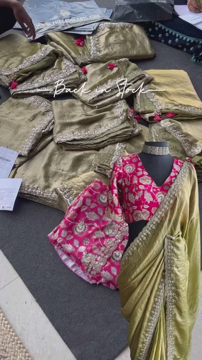 Green soft tissue saree with pink floral embroidered blouse