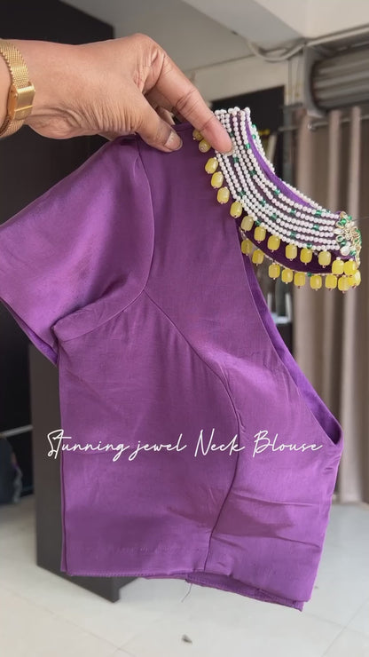 Yellow floral satin saree with purple jewel neck hand work blouse