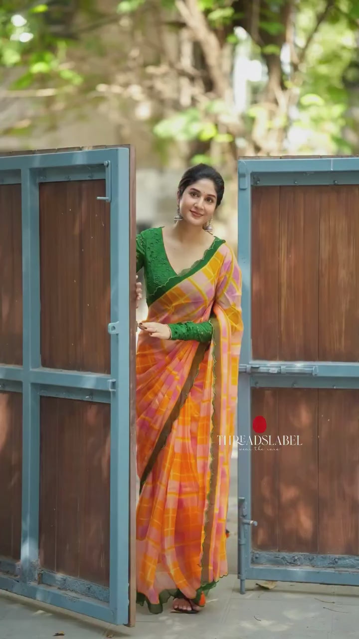 Orange viscose jute saree with green hakoba blouse
