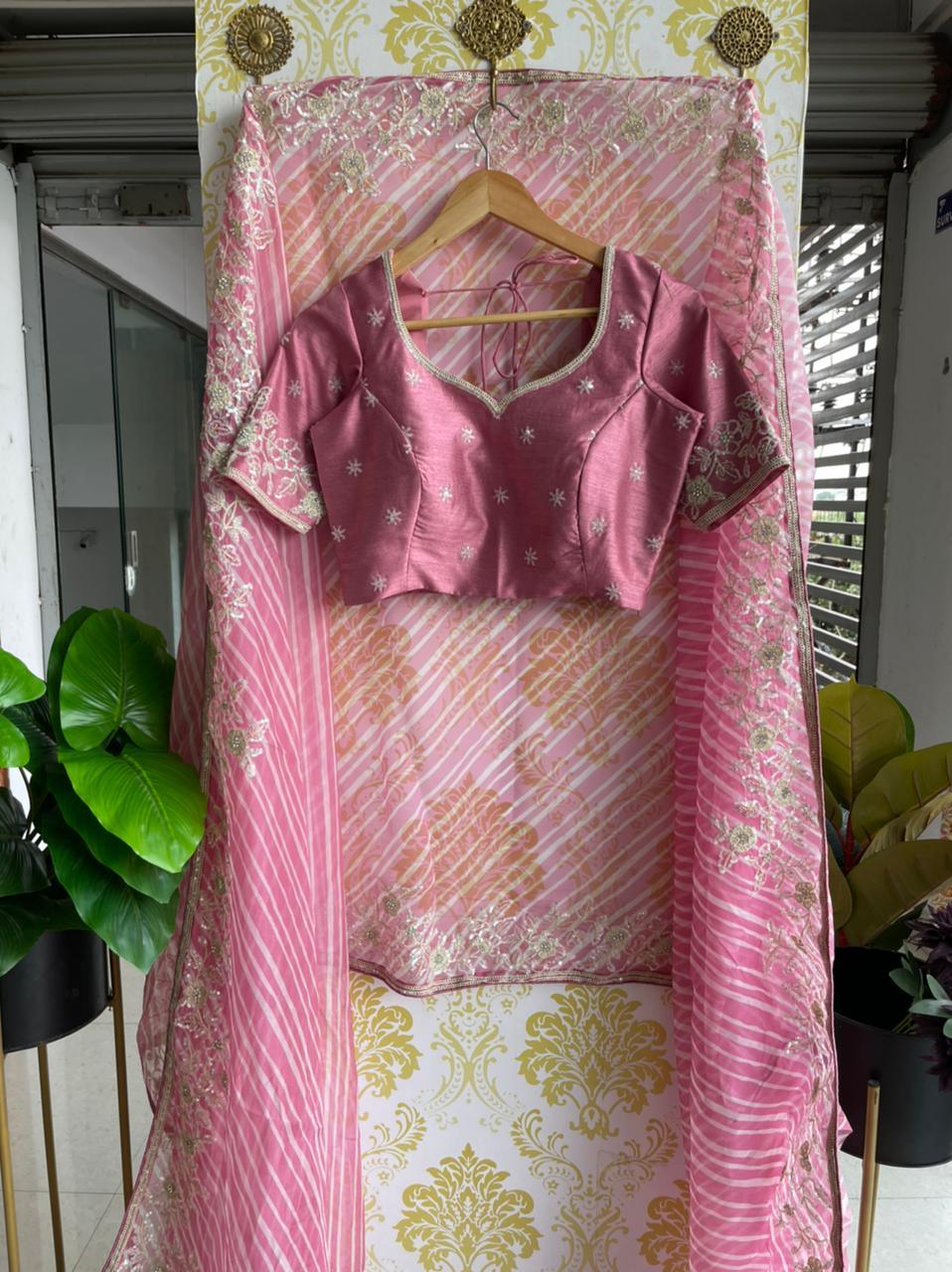 Lehariya pink organza saree with blue hand worked blouse - Threads