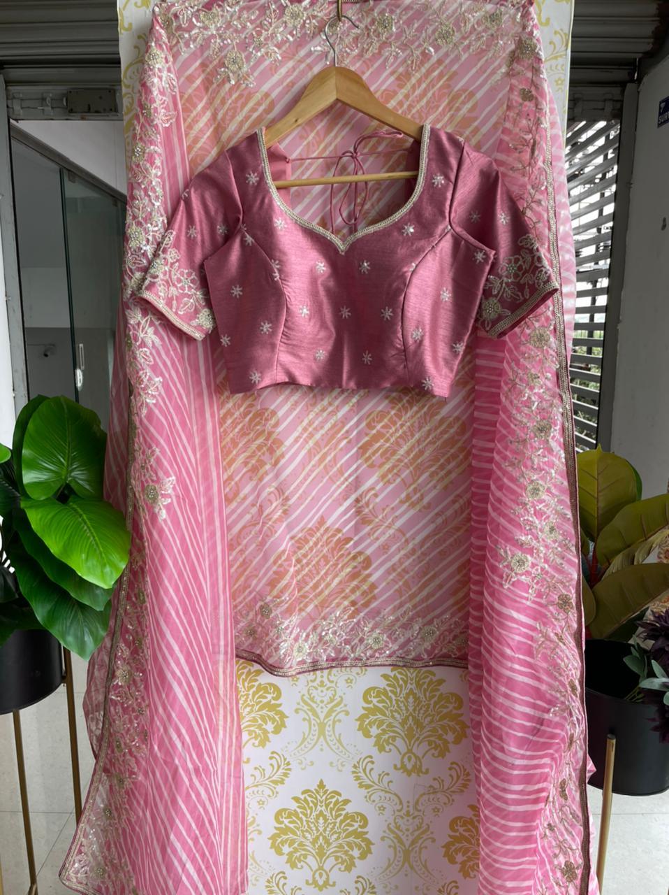 Lehariya pink organza saree with blue hand worked blouse - Threads